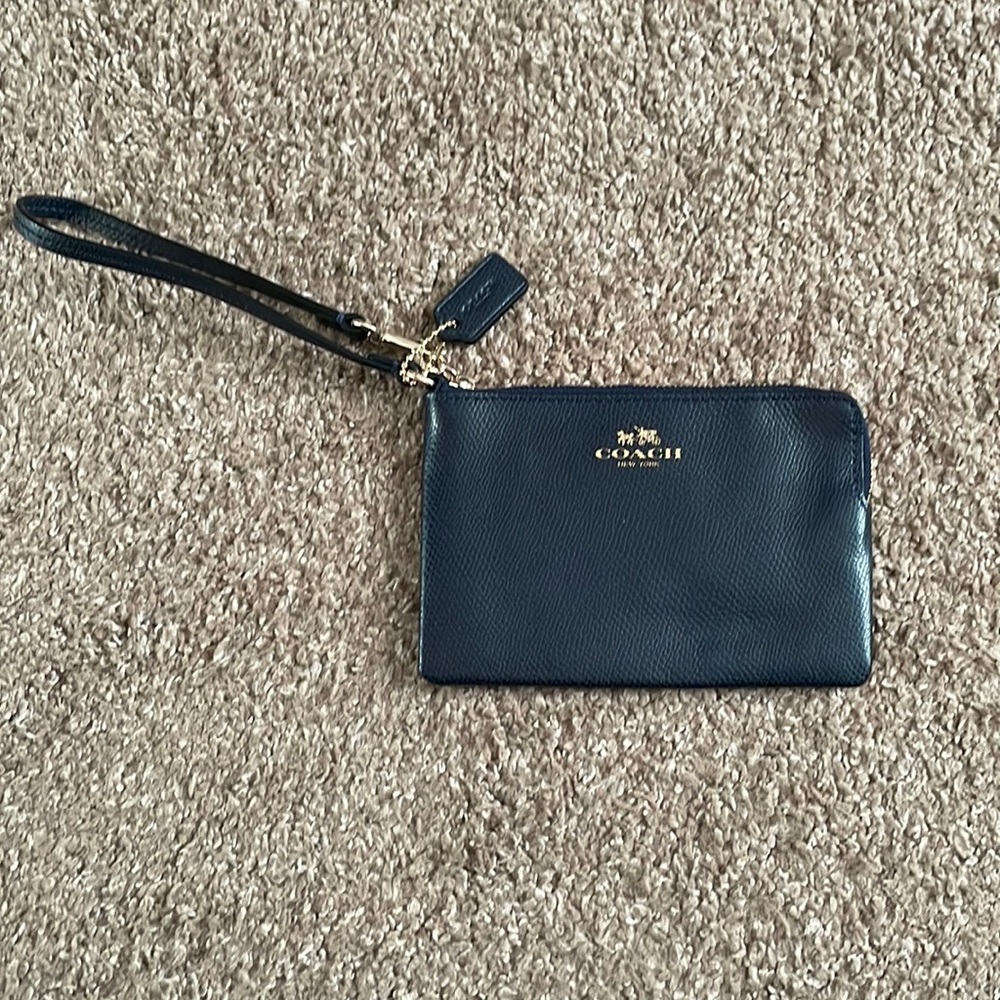 Navy blue Coach wristlet. Barely used- great condition.